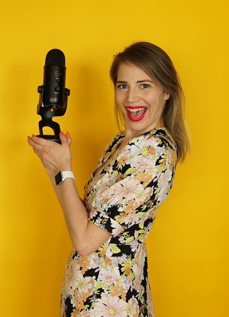 simple steps to start a podcast emily holding microphone on yellow background