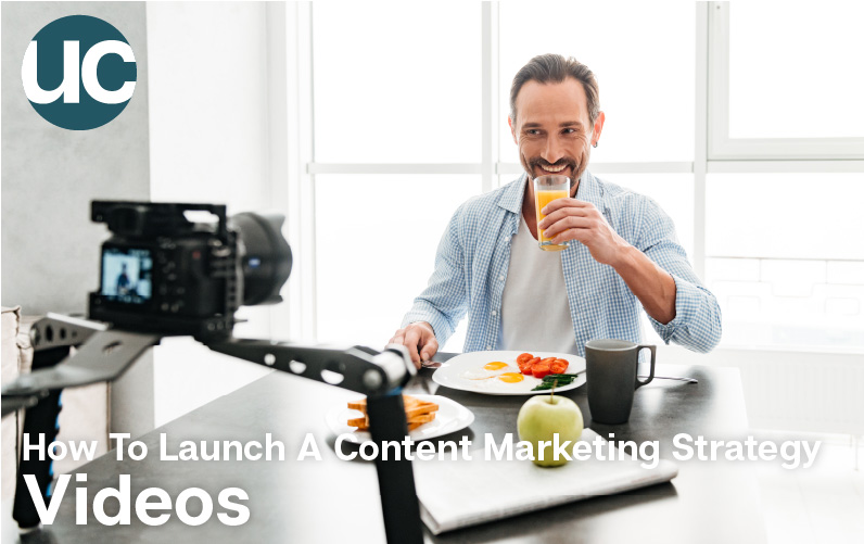 How To Launch A Content Marketing Strategy - Videos - A man films himself at breakfast drinking some orange juice.